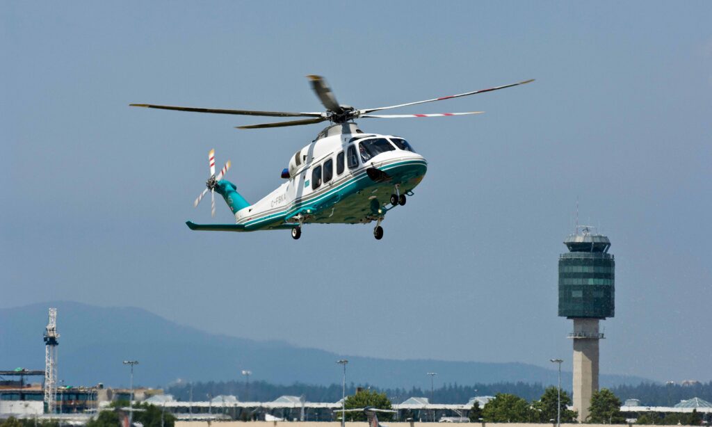 A London Air Services chartered helicopter landing at an airport in the Pacific Northwest on a sunny day